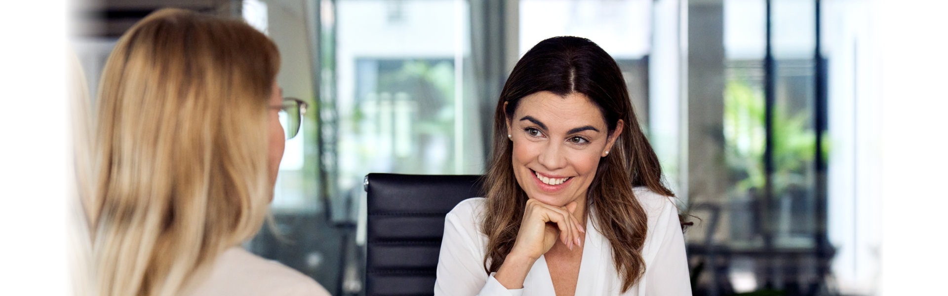 A woman smiling to another woman